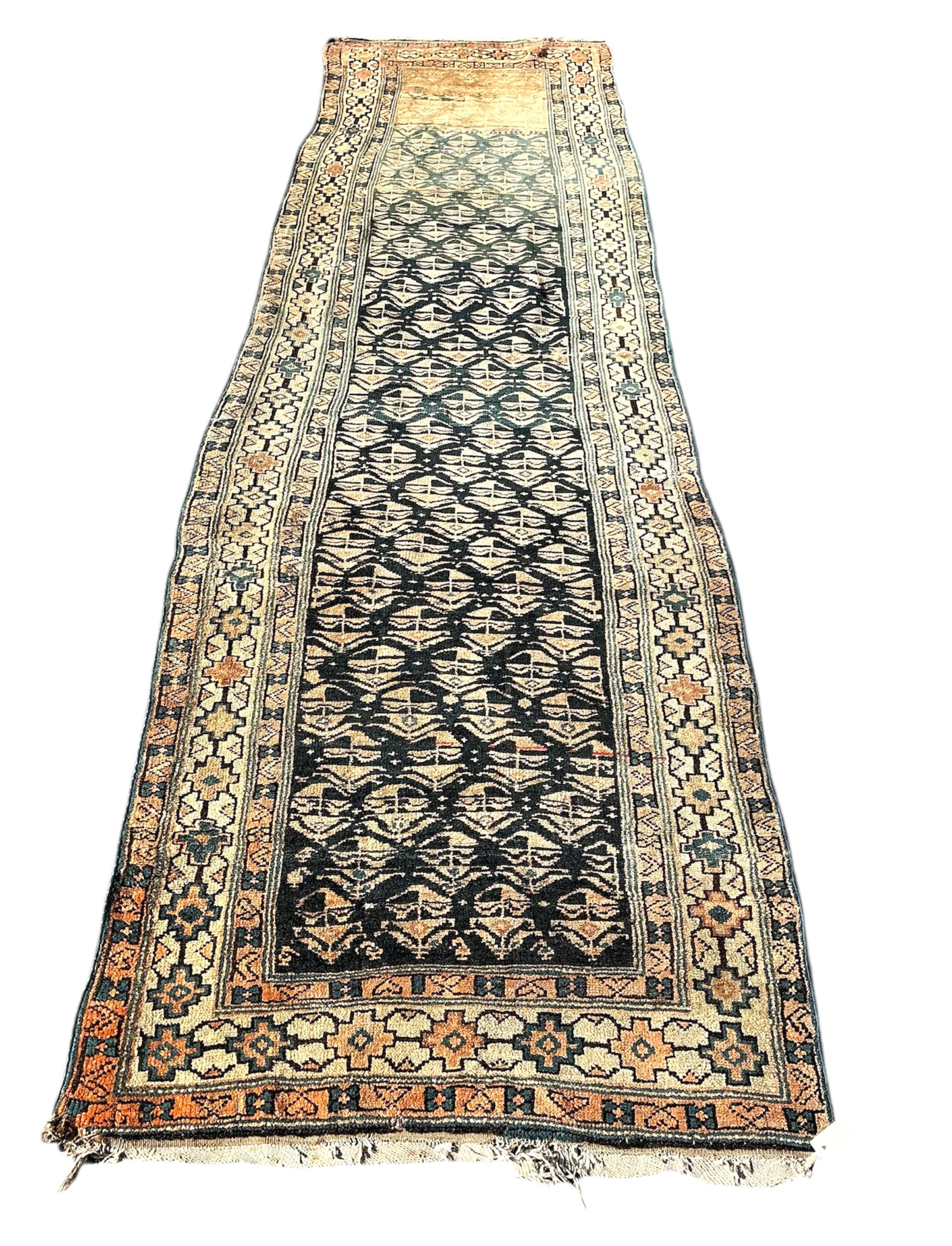 An antique Caucasian blue ground runner, heavily worn and faded, 342 x 96cm